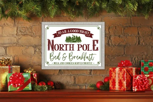 New North Pole Bed and Breakfast 15" x 21.5" Framed Christmas Wall Decor Art Print Sign Poster in a White Wooden Frame with UV Acrylic and Hangers Wall